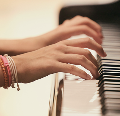 Close up of a woman's healthy, eczema-free hands as she plays the piano